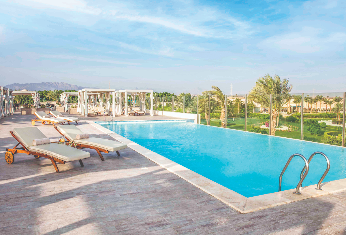 A small handful of sun loungers surrounding a large pool at Jaz Makadi Aquaviva.