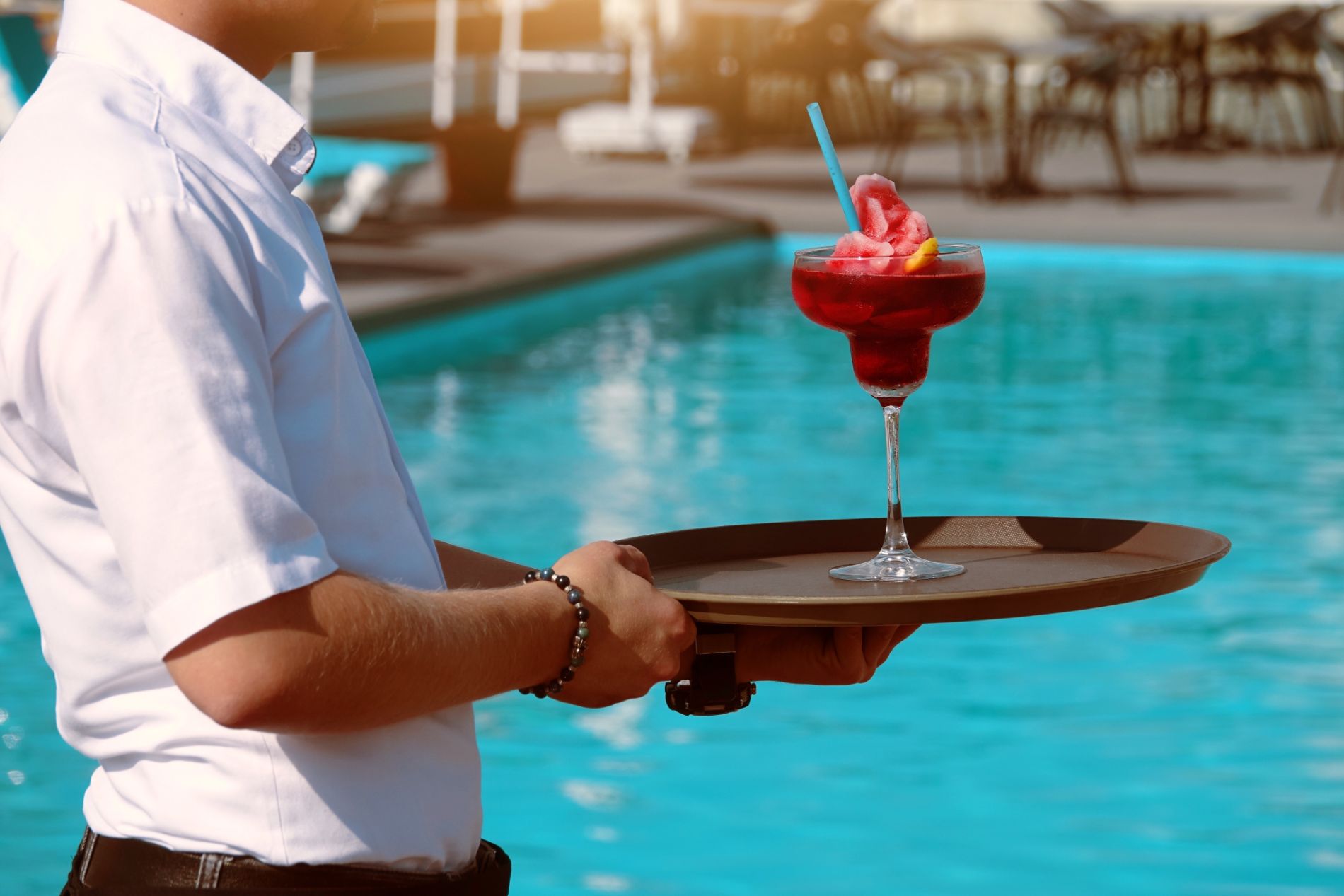 Waiter serving Bright Cocktail by Swimming Pool