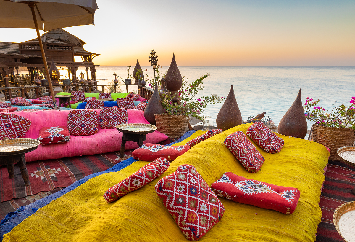 Beachfront restaurant in Egypt with outdoor seating pictured at sunset