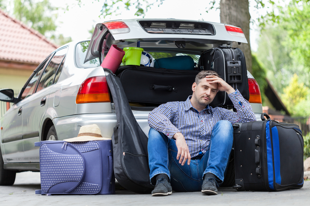 Man taking a break, packing for a trip