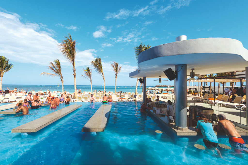 Outdoor pool and swim up bar by the beach at the Riu Reggae hotel in Jamaica