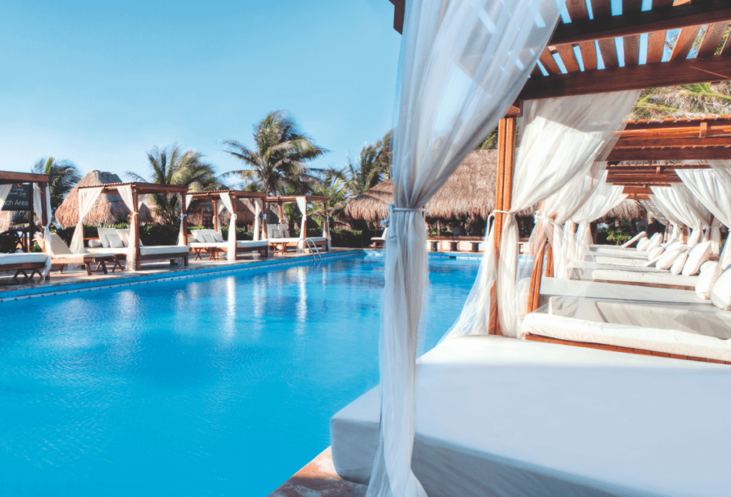 Outdoor pool with luxury cabanas at the TUI BLUE For Two TUI BLUE El Dorado Seaside Suites in Mexico